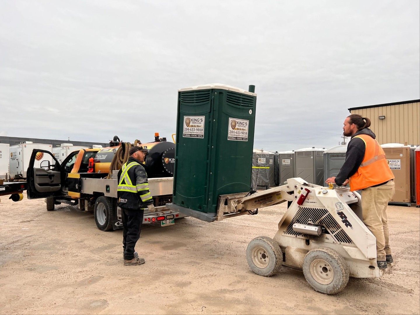 Portable toilet being loaded on a truck for a wedding.